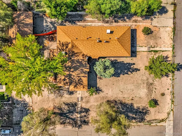 an aerial view of a house with a yard