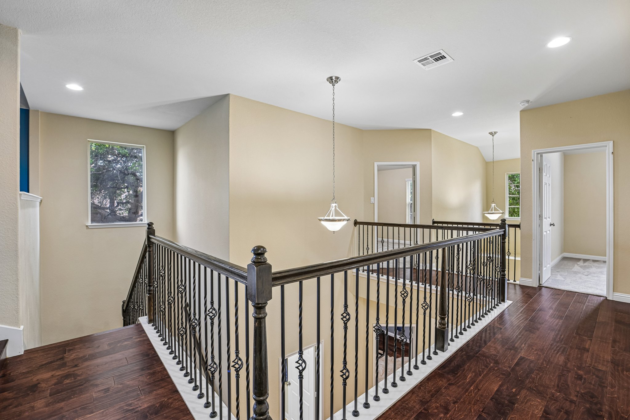 1924 Granite Springs Road Leander, TX 78641 - Photo 24 of 36 Rich hardwood floors complement an elegant wrought iron railing ascending to the second story landing.