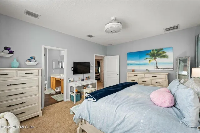a bedroom with a bed and flat screen tv