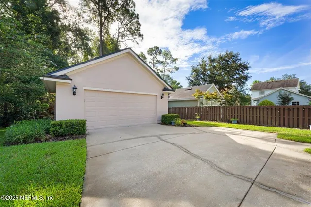 a view of backyard of house and garage