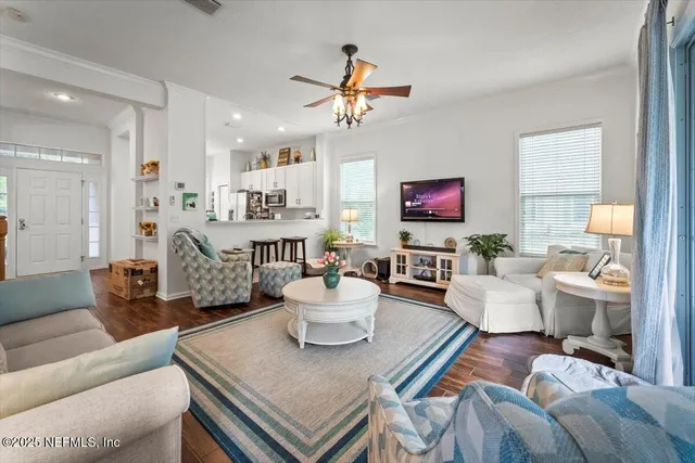 a living room with furniture and wooden floor