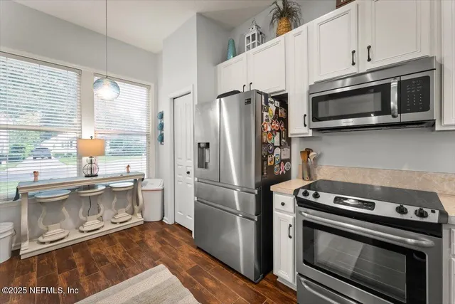 a kitchen with a stove and a microwave