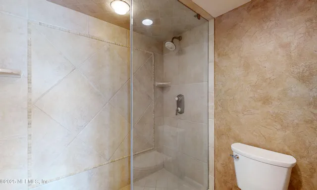 a bathroom with a sink a shower and a mirror