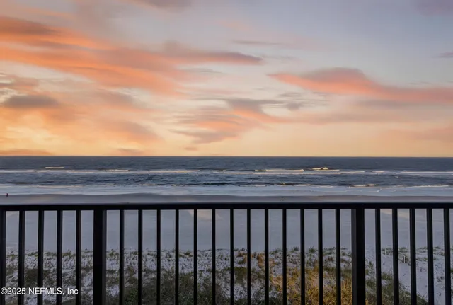 a view of a building with car parked