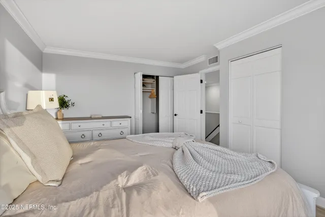 a view of walk in closet and bedroom