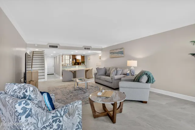 a kitchen with stainless steel appliances granite countertop a sink a stove and a wooden cabinets