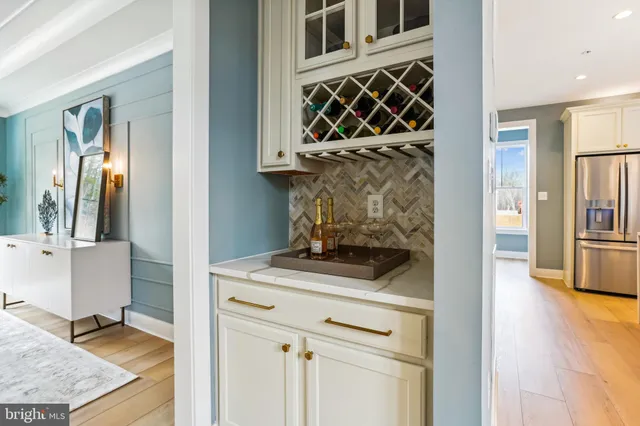 a large kitchen with a large counter top a sink a stove and a refrigerator