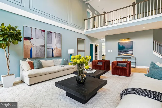 a living room with furniture a rug and a chandelier