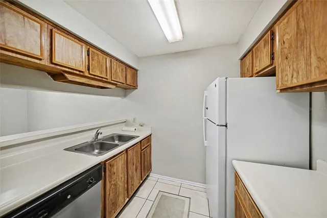 a kitchen with stainless steel appliances a refrigerator and a sink