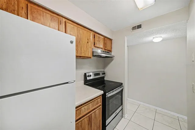 a kitchen with stainless steel appliances a refrigerator a stove a microwave and cabinets