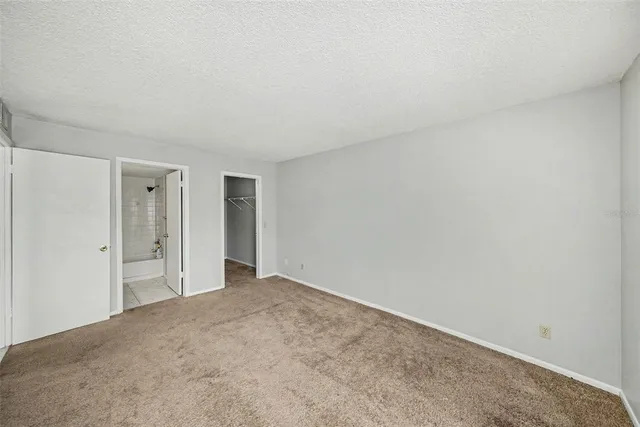 a view of an empty room and closet