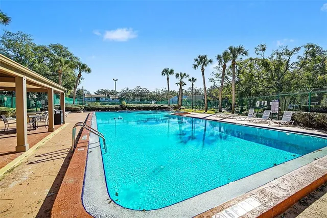 a view of a swimming pool with lounge chair
