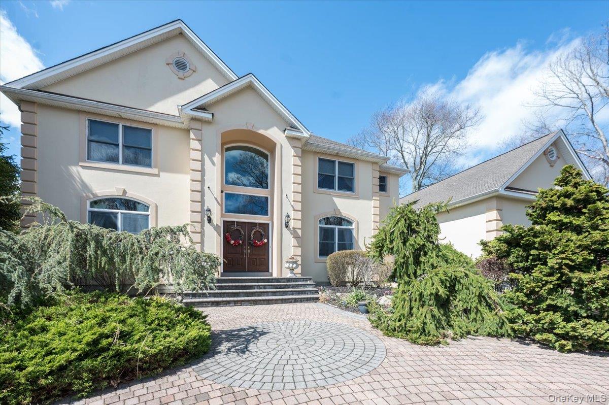 View of front of property with stucco siding and entry steps