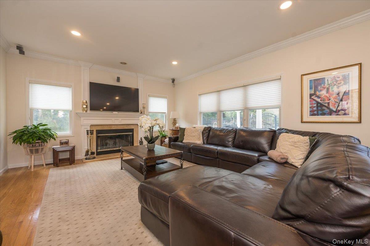 129 Round Swamp Road Huntington, NY 11743 - Photo 11 of 50 Very large family room with hardwood floors, fireplace, decorative molding details and plenty of windows.