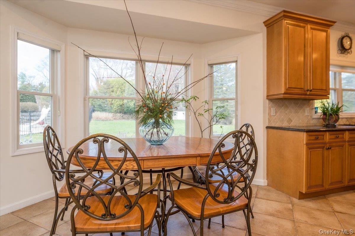 129 Round Swamp Road Huntington, NY 11743 - Photo 19 of 50 Right off the kitchen with large windows framing the space.