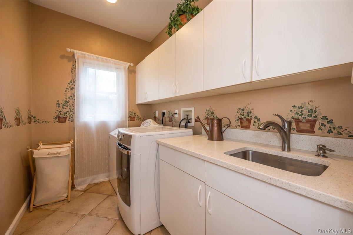 129 Round Swamp Road Huntington, NY 11743 - Photo 21 of 49 First floor laundry with plenty of cabinetry for storage and utility sink with plenty of counter space for folding.