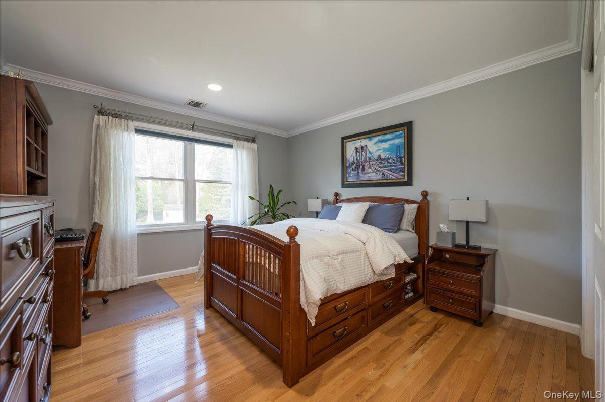 129 Round Swamp Road Huntington, NY 11743 - Photo 30 of 50 Wood flooring, crown and baseboard moldings, recessed lighting and large closet.