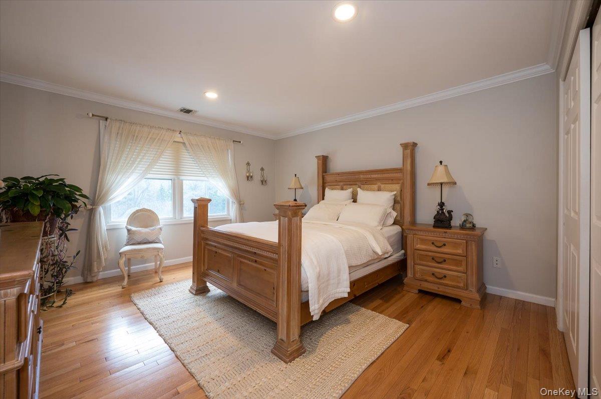 129 Round Swamp Road Huntington, NY 11743 - Photo 31 of 50 Wood flooring, crown and baseboard moldings, recessed lighting and large closet.