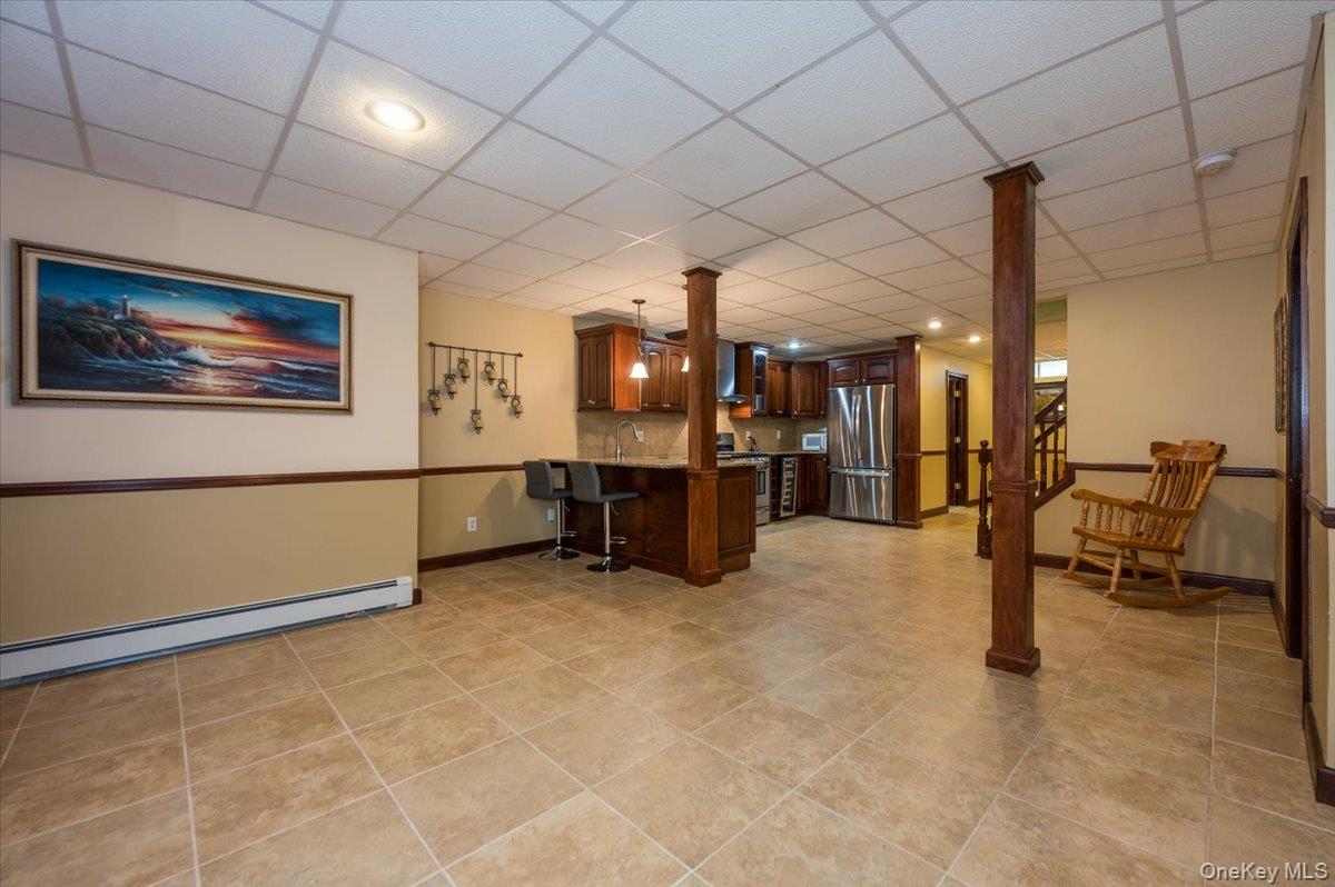 129 Round Swamp Road Huntington, NY 11743 - Photo 33 of 50 Finished space with tile flooring, molding details and plenty of space for various entertaining uses.