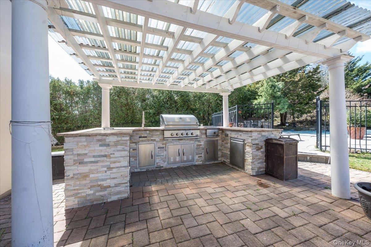 129 Round Swamp Road Huntington, NY 11743 - Photo 42 of 50 Built in outdoor kitchen with pergola for shade.