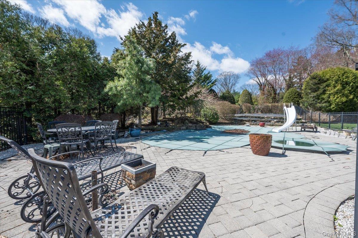 129 Round Swamp Road Huntington, NY 11743 - Photo 44 of 50 Inground pool with spacious stone paver patio and fully fenced for safety.