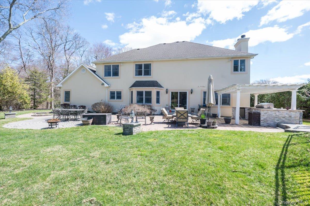 129 Round Swamp Road Huntington, NY 11743 - Photo 46 of 50 View of patio and expansive backyard and lawn area.