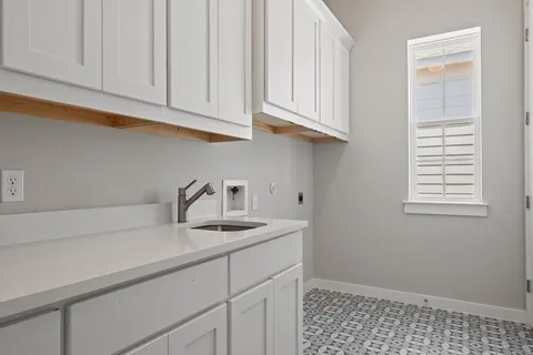 a kitchen with appliances cabinets and a window