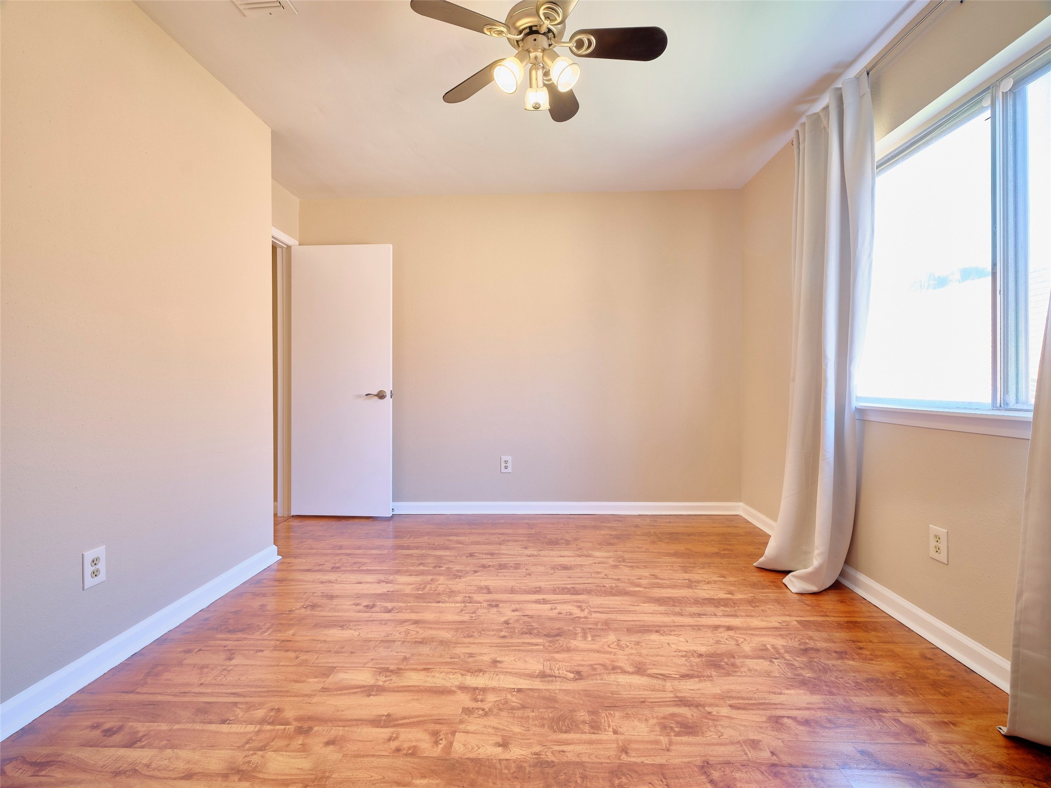 8315 Terrace Wind Lane Houston, TX 77040 - Photo 29 of 50 wooden floor in an empty room with a window
