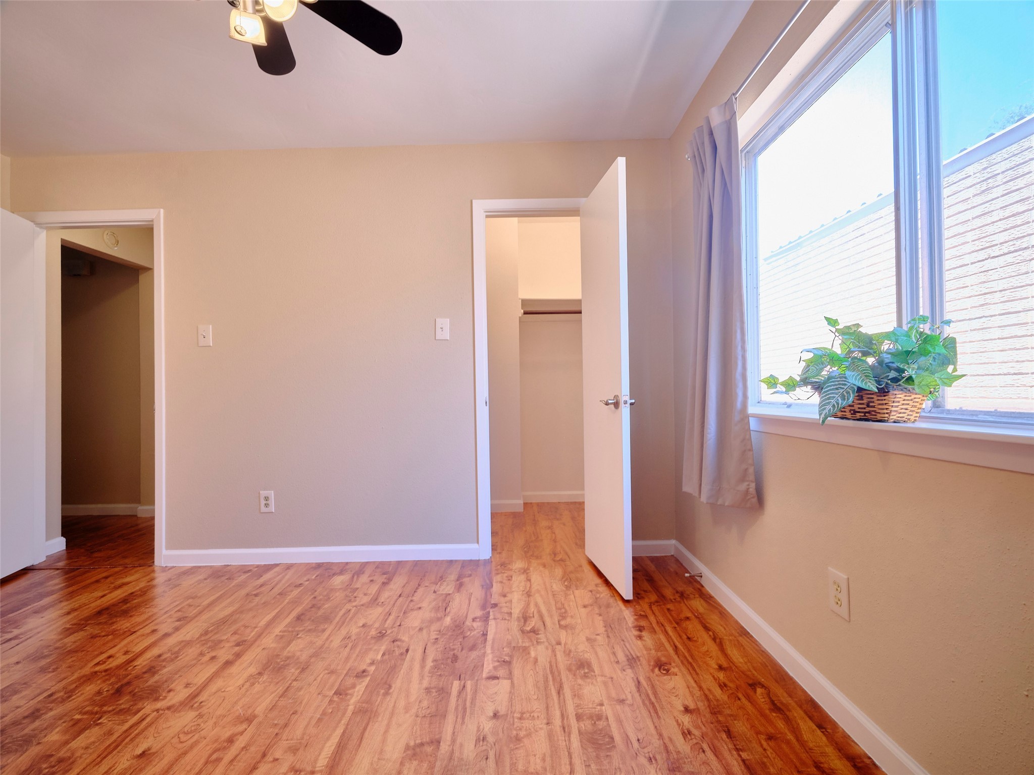 8315 Terrace Wind Lane Houston, TX 77040 - Photo 34 of 50 a view of an empty room with wooden floor and windows