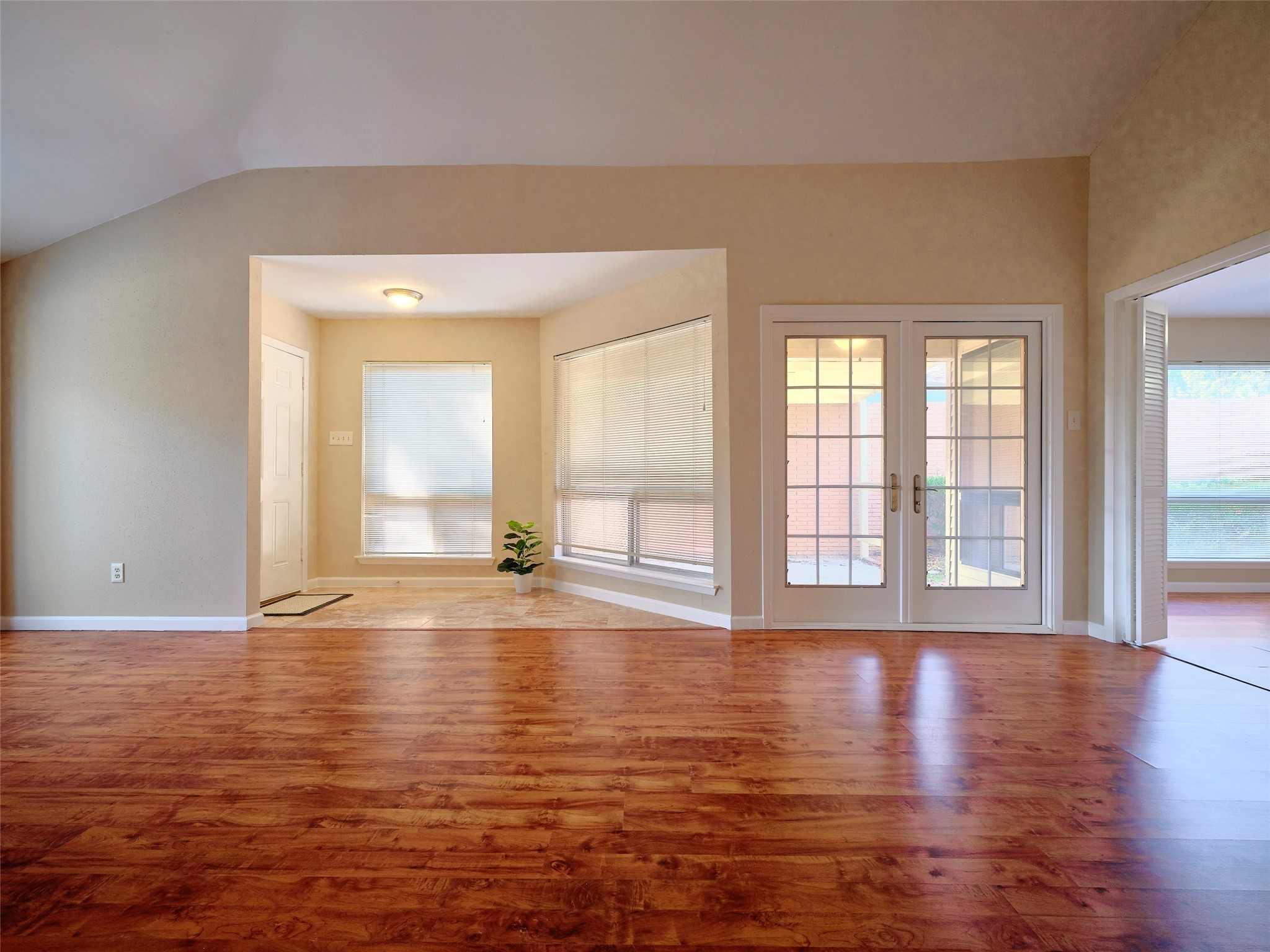 8315 Terrace Wind Lane Houston, TX 77040 - Photo 6 of 50 a view of an empty room with wooden floor and a window
