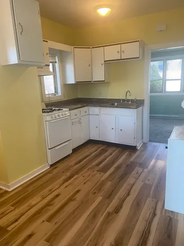 a kitchen with granite countertop a sink and cabinets