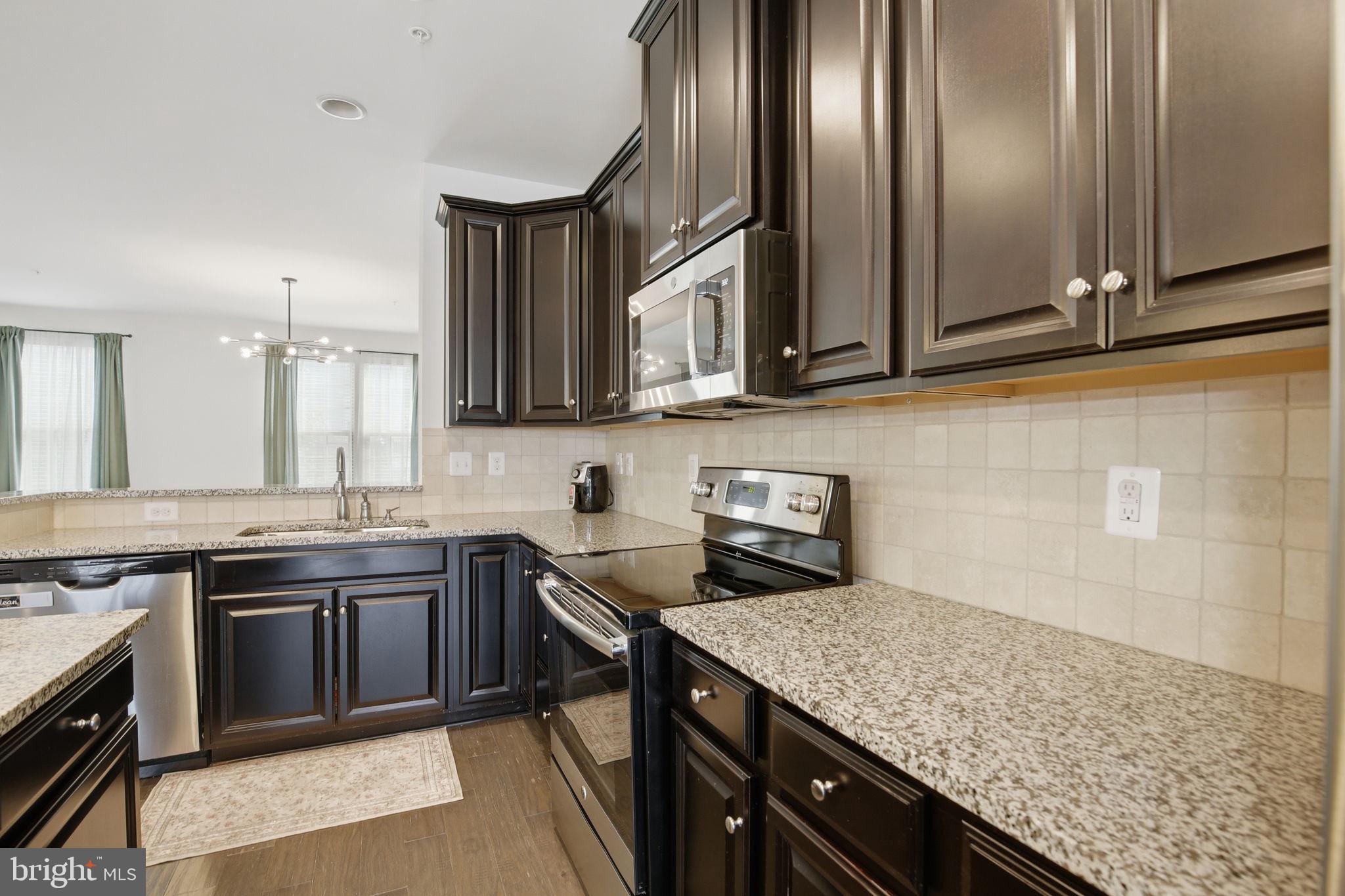 2784 Fredericksburg Road Hanover, MD 21076 - Photo 21 of 60 a kitchen with stainless steel appliances granite countertop a sink stove and cabinets