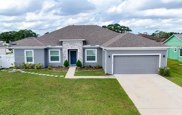 a front view of a house with a yard and garage