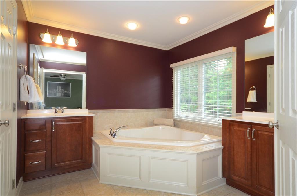 941 Montclair Drive Coraopolis, PA 15108 - Photo 14 of 20 The master bath offers two separate vanities, a garden tub with tile surround, crown molding and tile flooring.