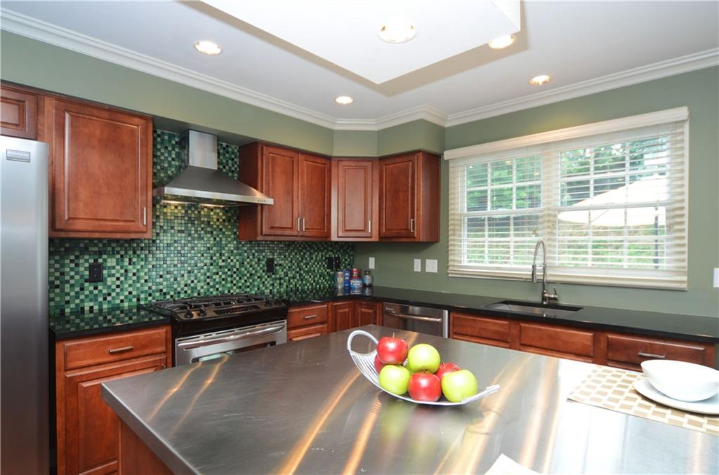 941 Montclair Drive Coraopolis, PA 15108 - Photo 6 of 20 The kitchen offers granite countertops, a custom tile backsplash and upgraded stainless appliances.