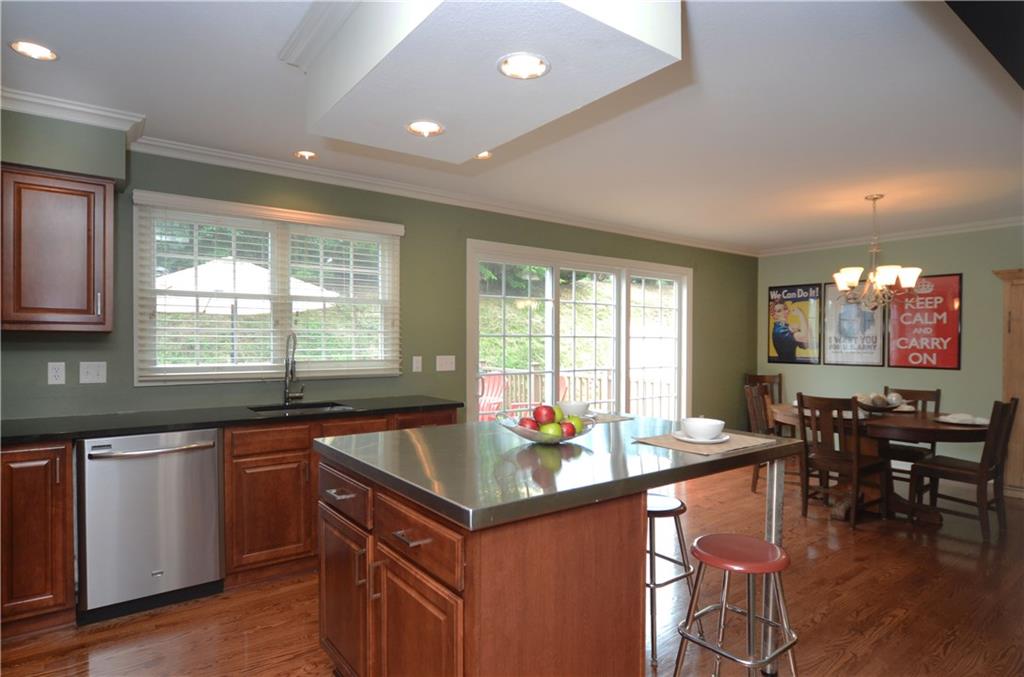 941 Montclair Drive Coraopolis, PA 15108 - Photo 8 of 20 The kitchen opens into the dining area. Both rooms include gleaming hardwood floors.