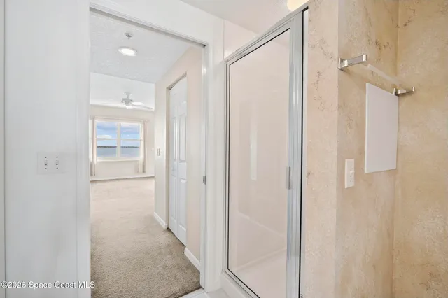 a bathroom with a shower and a glass door