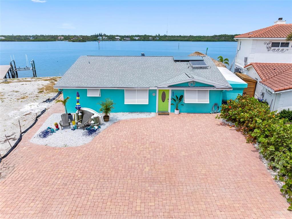 an aerial view of a house with a yard and balcony