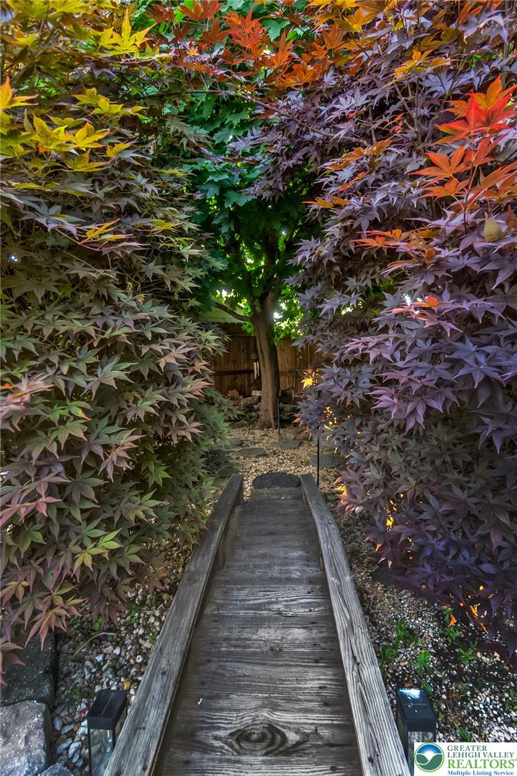 365 Rock Street Easton, PA 18042 - Photo 48 of 50 A vibrant garden path winds through colorful foliage, offering a private, secluded escape.