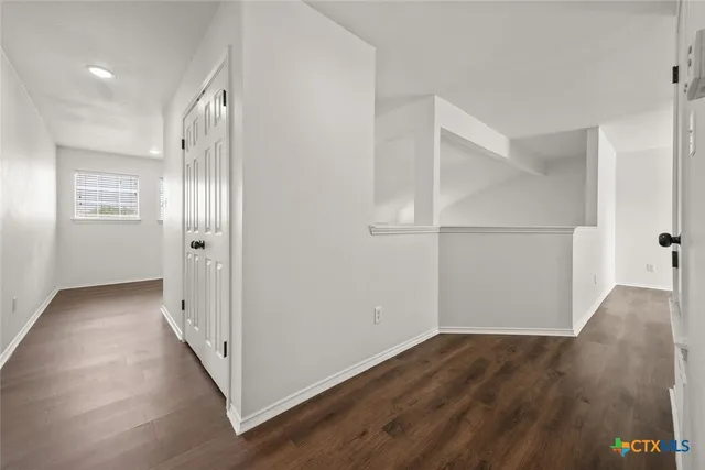 wooden floor in an empty room with a gallery