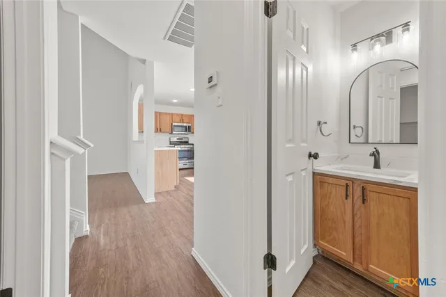 a bathroom with a double vanity sink and a mirror