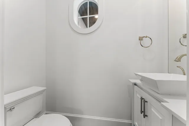 a large kitchen with kitchen island a stove a sink a refrigerator and a refrigerator