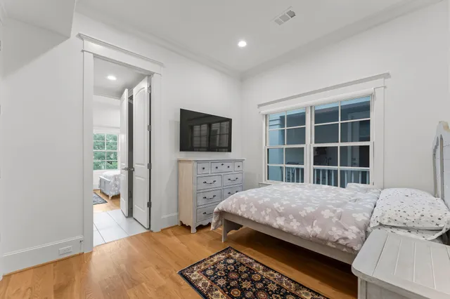 a spacious bedroom with a large bed and a chandelier