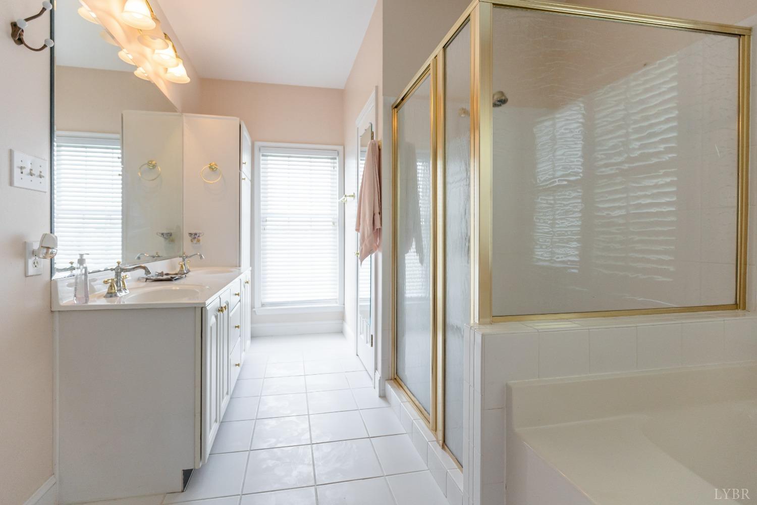 1692 West Courthouse Road Crewe, VA 23930 - Photo 33 of 67 a bathroom with a double vanity sink a mirror and a shower