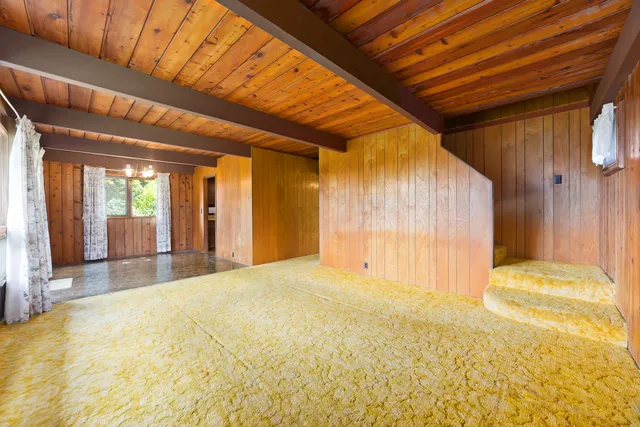 a view of an empty room with a fireplace