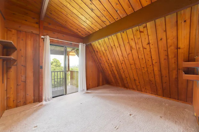 a spacious bedroom with a large bed and a chandelier