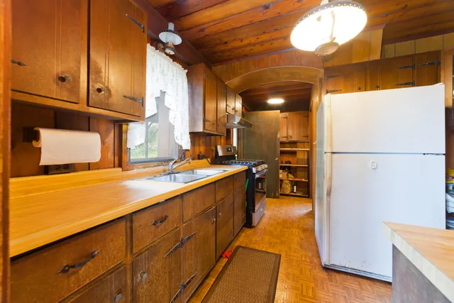 a kitchen with sink cabinets and stove