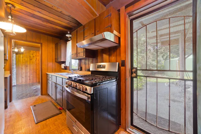 a kitchen with stainless steel appliances granite countertop a stove and a refrigerator