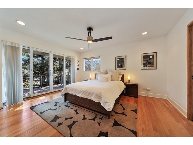 2921 Sheridan Road Evanston, IL 60201 - Photo 21 of 25 a spacious bedroom with a large bed and a chandelier