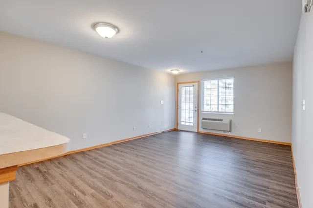 a view of a kitchen with wooden floor and a sink